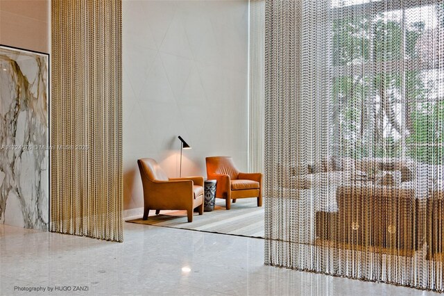 exercise room with french doors, a high ceiling, carpet, and a water view