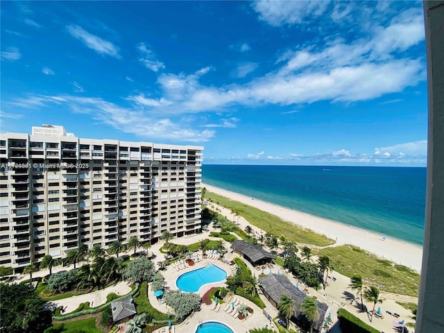 birds eye view of property with a view of the beach and a water view