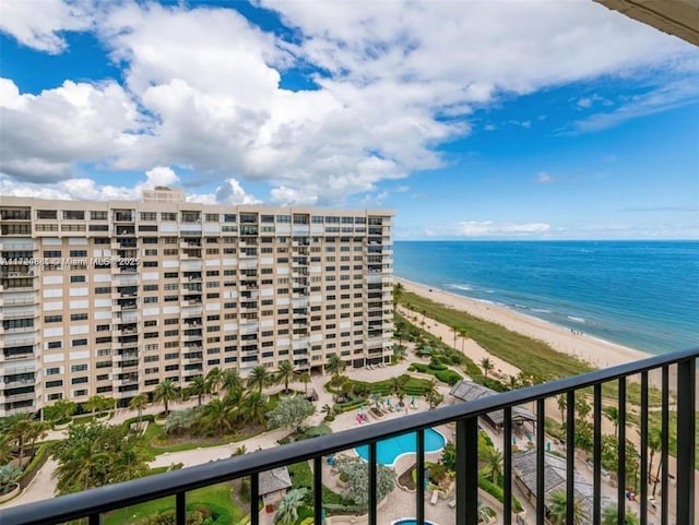 balcony with a water view and a beach view