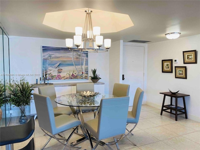 tiled dining room featuring a notable chandelier