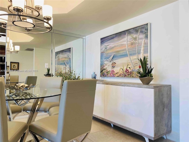 tiled dining space with an inviting chandelier