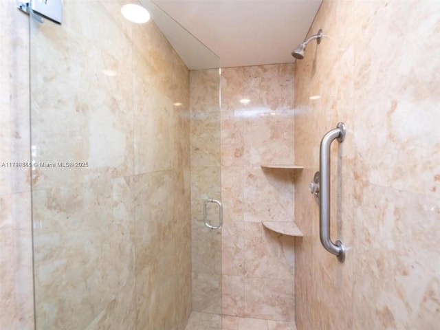 bathroom with a shower with shower door