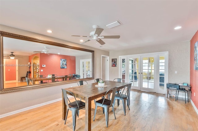 dining space with light hardwood / wood-style flooring and french doors