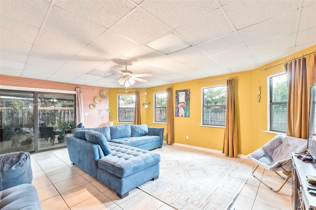 tiled living room featuring a paneled ceiling and ceiling fan