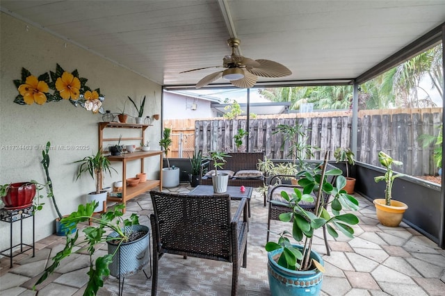 sunroom / solarium featuring ceiling fan