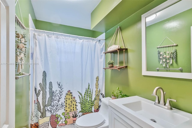 bathroom with vanity, toilet, and curtained shower