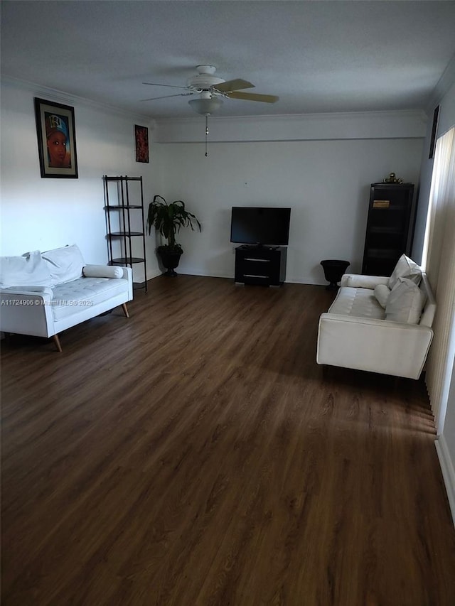 living room with dark hardwood / wood-style flooring, ceiling fan, and crown molding