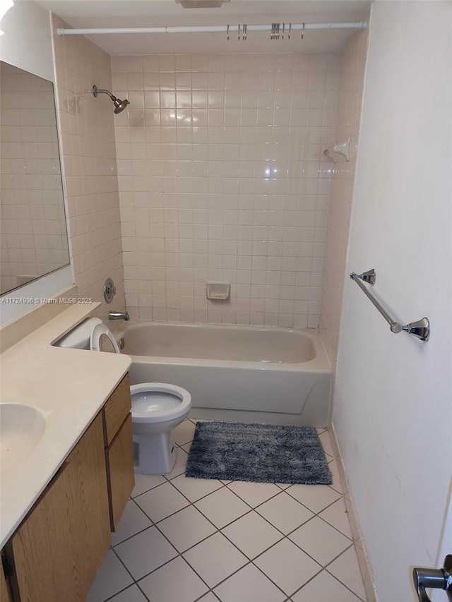 full bathroom featuring toilet, vanity, tile patterned floors, and tiled shower / bath combo