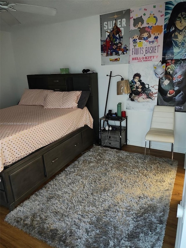 bedroom with ceiling fan and dark hardwood / wood-style floors