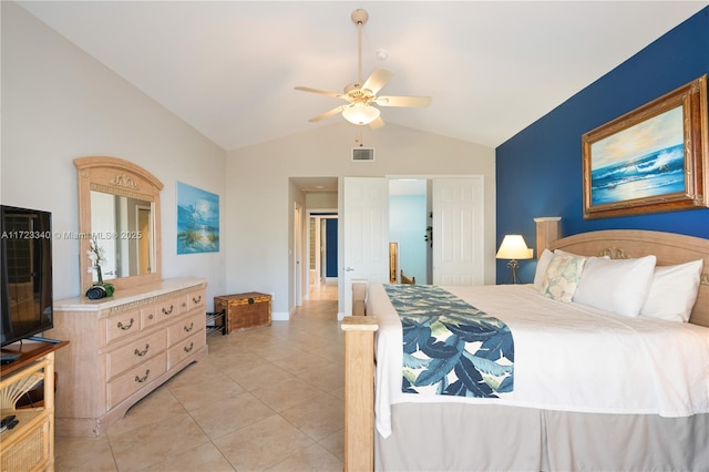 tiled bedroom with ceiling fan and vaulted ceiling