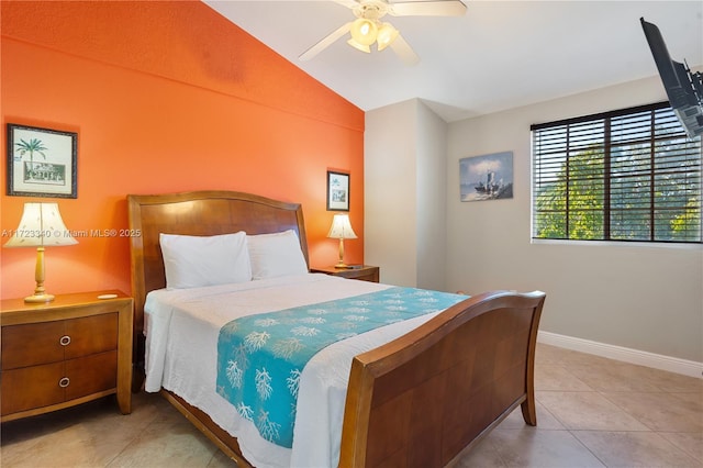 tiled bedroom with ceiling fan and vaulted ceiling