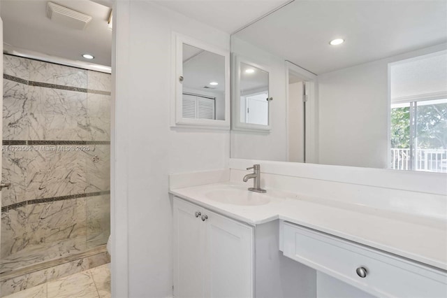 bathroom featuring vanity and a shower with shower door