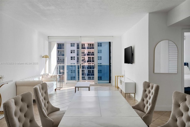 tiled living room featuring expansive windows and a textured ceiling