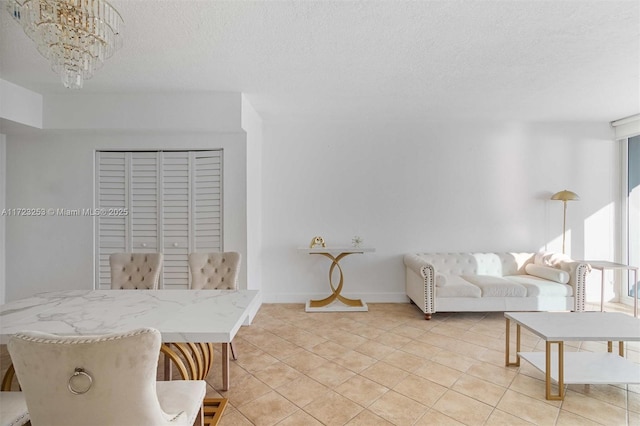 dining area with light tile patterned flooring, a textured ceiling, and a notable chandelier