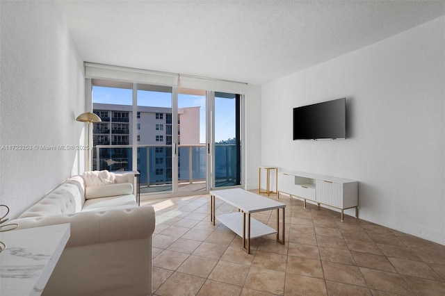 living room with floor to ceiling windows, light tile patterned floors, and a textured ceiling