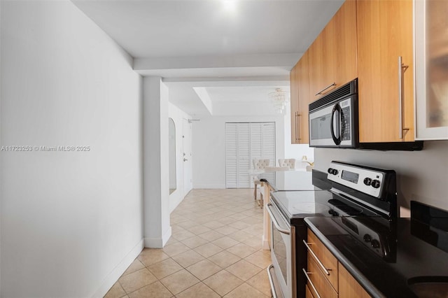 kitchen featuring light tile patterned flooring and electric stove