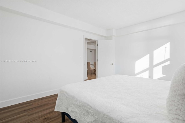 bedroom with dark wood-type flooring