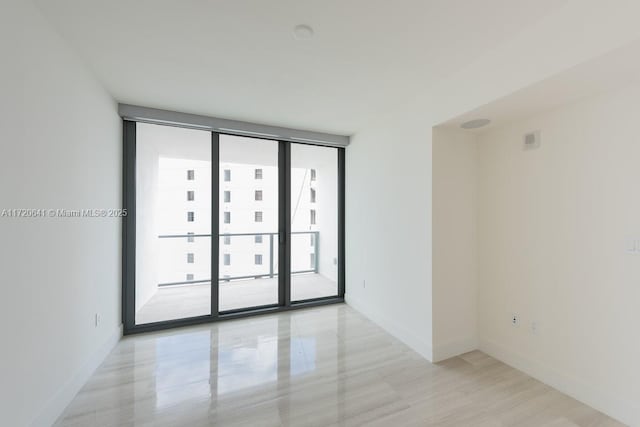 spare room featuring floor to ceiling windows