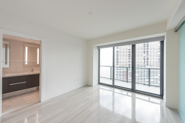 empty room with a healthy amount of sunlight and sink