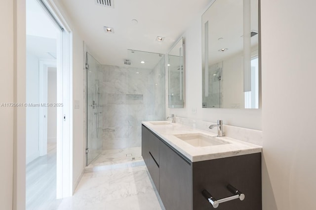 bathroom with vanity and a shower with shower door