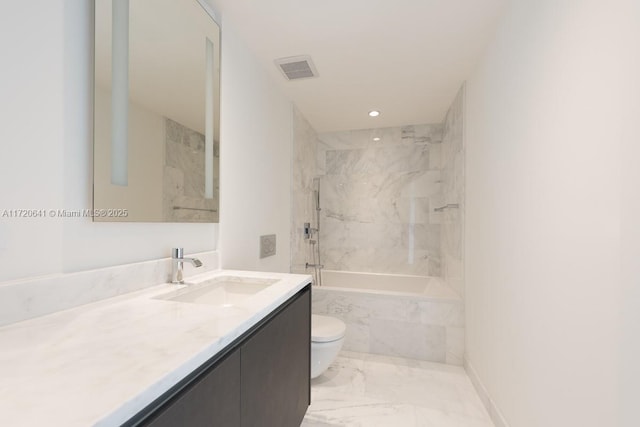 full bathroom with vanity, tiled shower / bath combo, and toilet