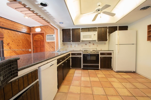 kitchen featuring dark brown cabinets, white appliances, a wall mounted AC, sink, and light tile patterned flooring