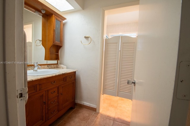 bathroom featuring tile patterned flooring and vanity