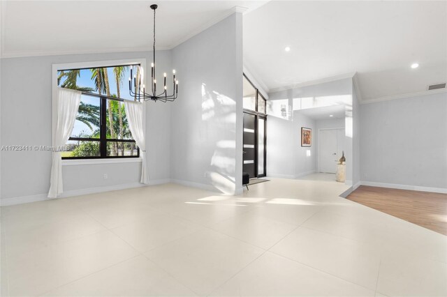 empty room featuring lofted ceiling, light wood-type flooring, ceiling fan, and crown molding