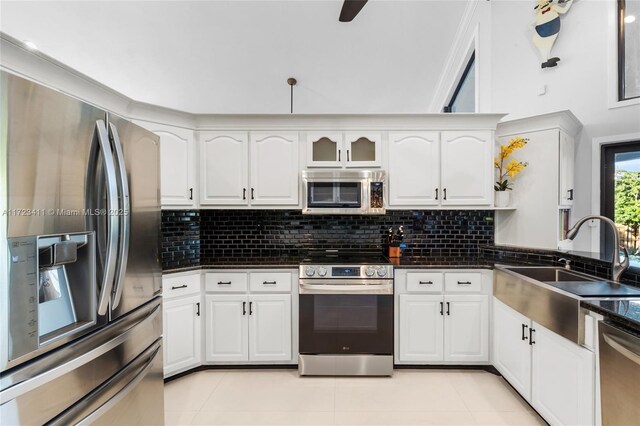 kitchen with stainless steel dishwasher, white cabinets, sink, and ceiling fan