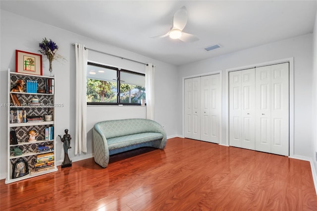 living area featuring ceiling fan and wood-type flooring