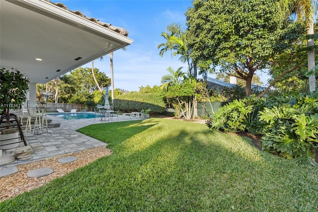 view of yard featuring a patio area and a fenced in pool