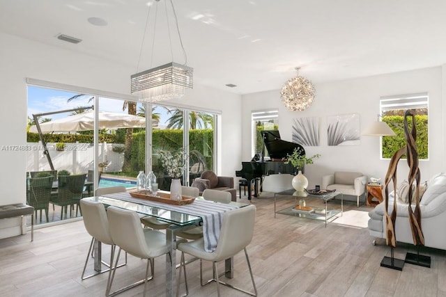 sunroom featuring an inviting chandelier