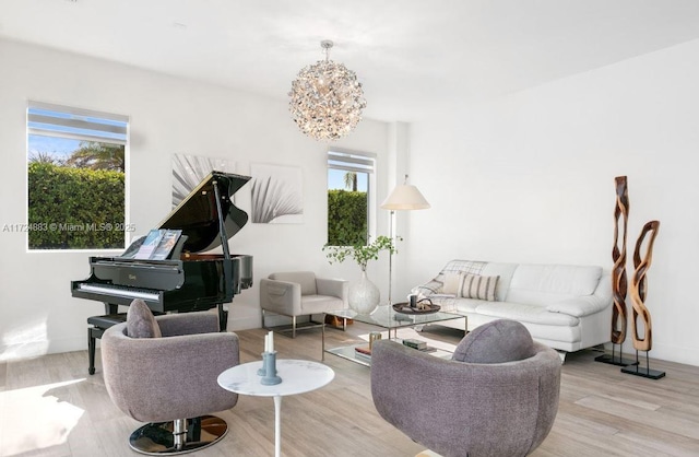 living room featuring light hardwood / wood-style floors, an inviting chandelier, and plenty of natural light