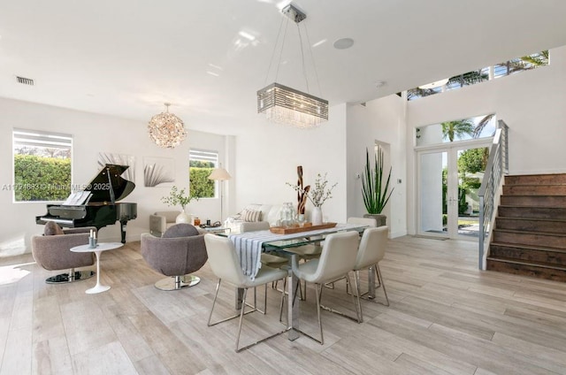 dining room with an inviting chandelier and light wood-type flooring