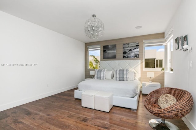 bedroom with dark wood-type flooring