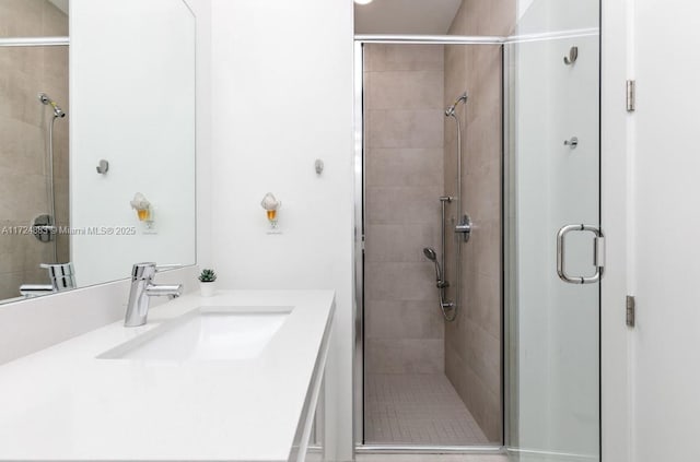 bathroom with vanity and a shower with shower door