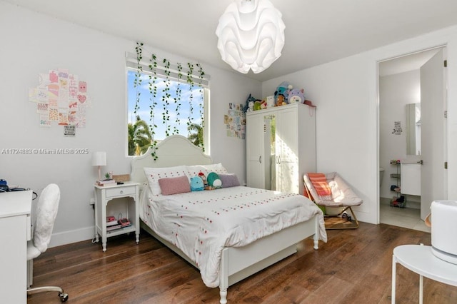 bedroom with dark wood-type flooring