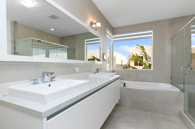 bathroom featuring separate shower and tub and vanity