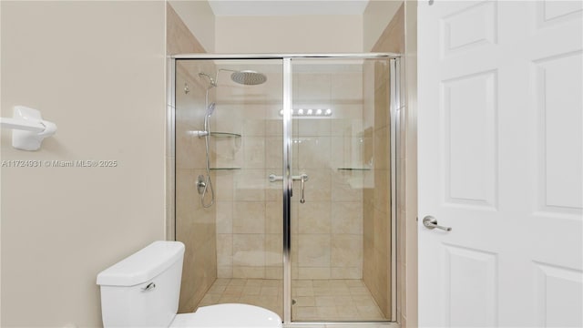 bathroom featuring toilet and walk in shower