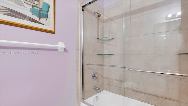 bathroom featuring bath / shower combo with glass door