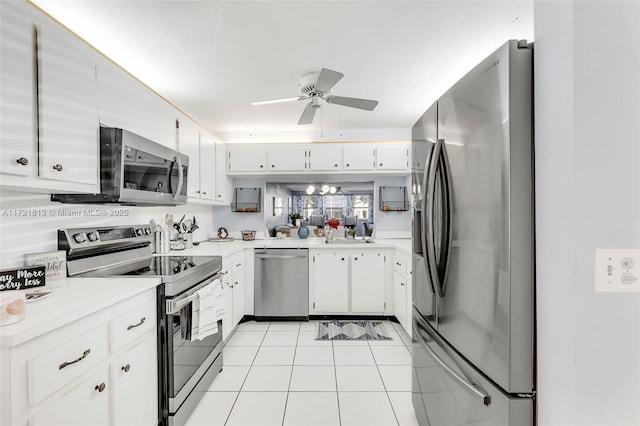 kitchen with white cabinets, stainless steel appliances, ceiling fan, and light tile patterned flooring