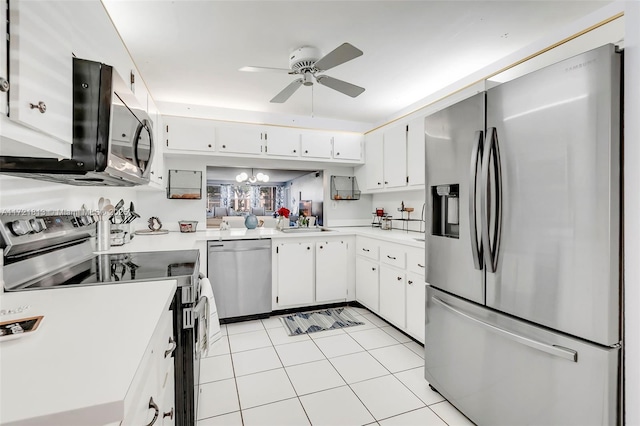 kitchen with ceiling fan with notable chandelier, sink, appliances with stainless steel finishes, light tile patterned flooring, and white cabinetry