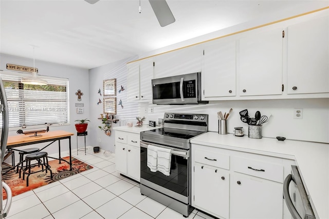 kitchen with stainless steel appliances, ceiling fan, light tile patterned floors, decorative light fixtures, and white cabinetry