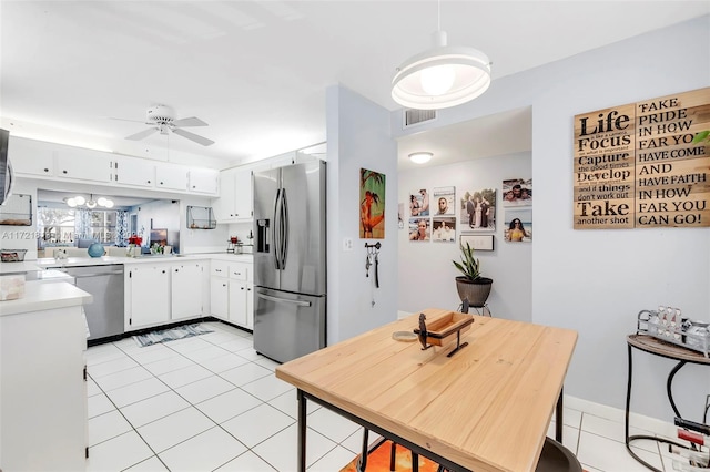 kitchen featuring white cabinetry, ceiling fan, light tile patterned floors, and appliances with stainless steel finishes