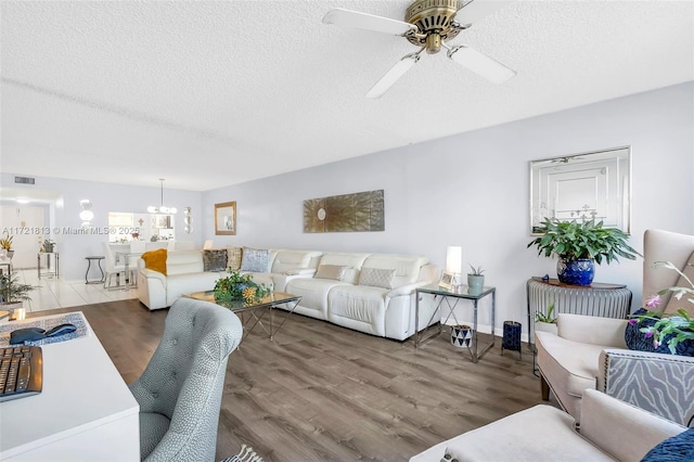 living room featuring radiator, ceiling fan, hardwood / wood-style floors, and a textured ceiling