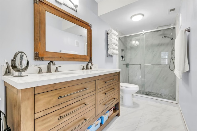 bathroom featuring vanity, toilet, and a shower with shower door