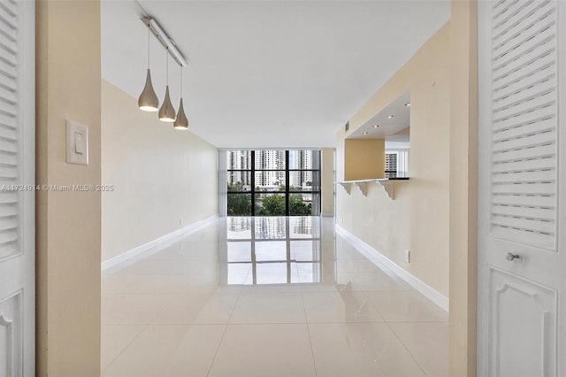 tiled empty room with floor to ceiling windows