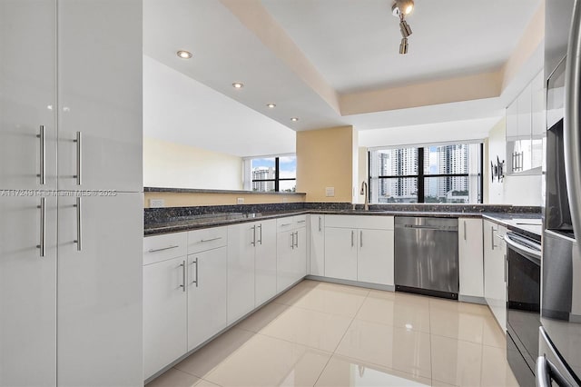 kitchen with white cabinetry, appliances with stainless steel finishes, sink, and light tile patterned floors