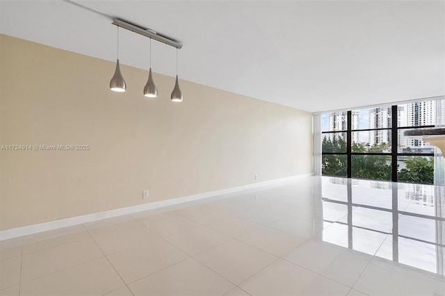 spare room with light tile patterned floors and expansive windows