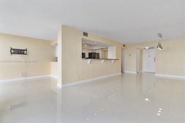 unfurnished living room featuring light tile patterned floors